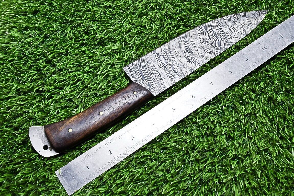 Close up view of the natural wood handle on a custom Damascus kitchen knife featuring brass pin details.
