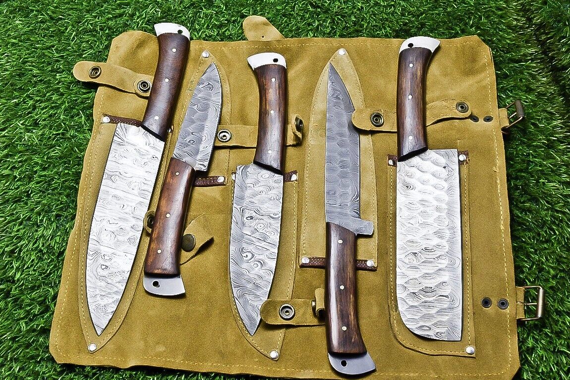 Close up view of the natural wood handle on a custom Damascus kitchen knife featuring brass pin details
