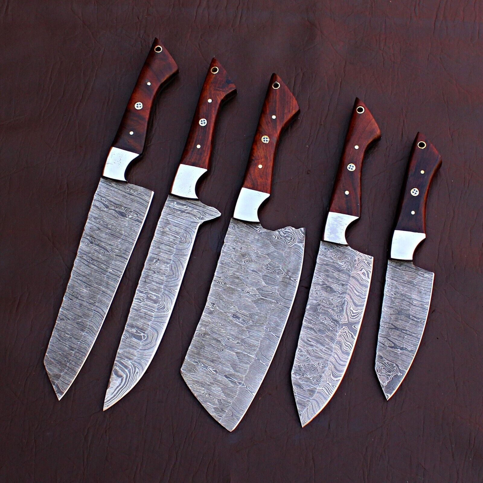 5 pieces Damascus steel chef knife set displayed next to a durable leather storage roll for culinary protection.