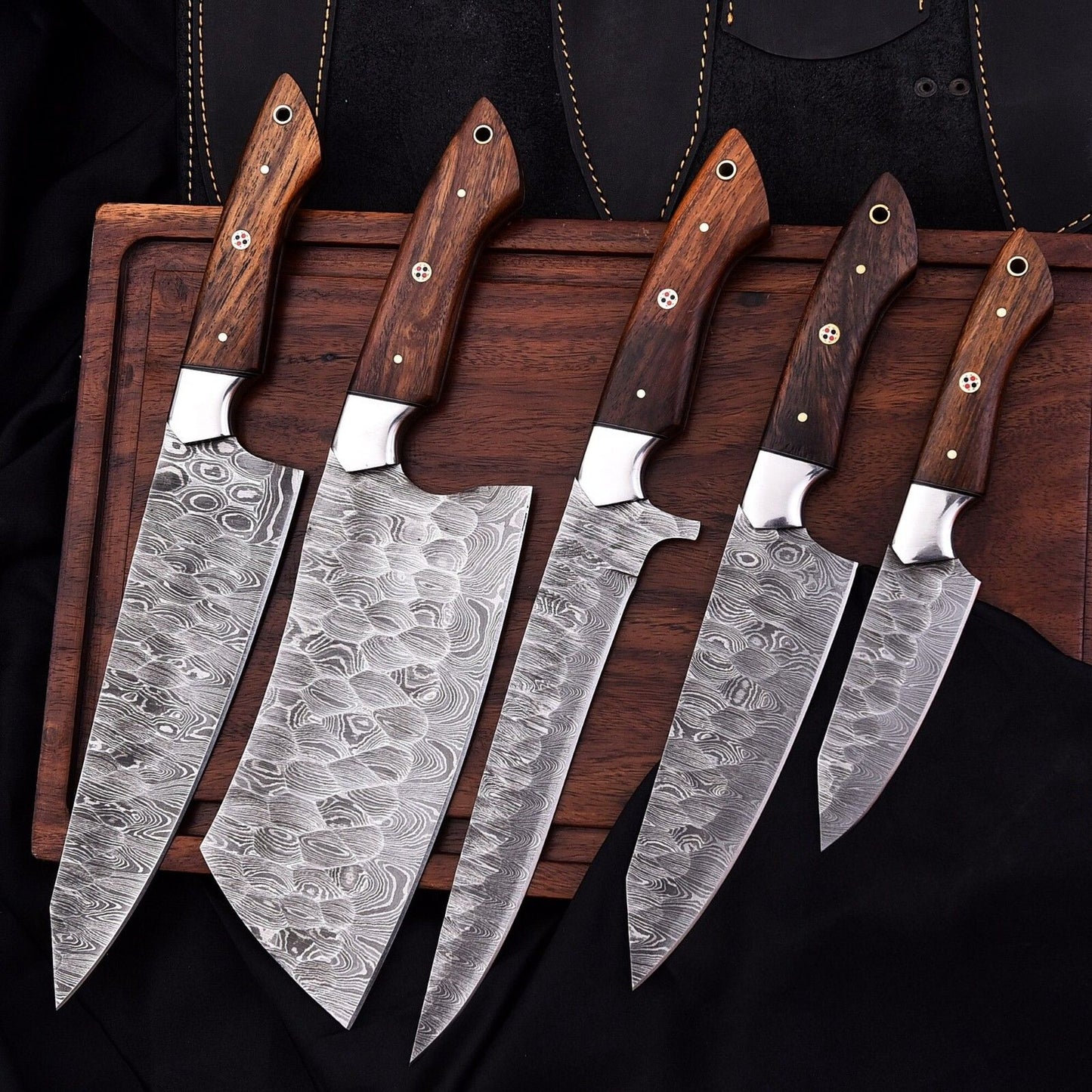 Professional Damascus steel chef knife resting on a rustic wood surface, highlighting the ergonomic rosewood handle and steel bolster.