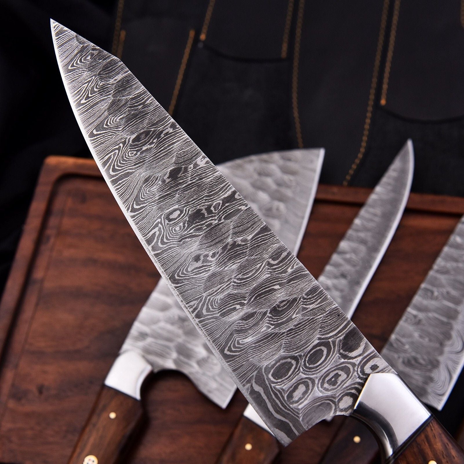 High resolution view of the signature Damascus steel blade pattern on a professional grade handmade chef knife.