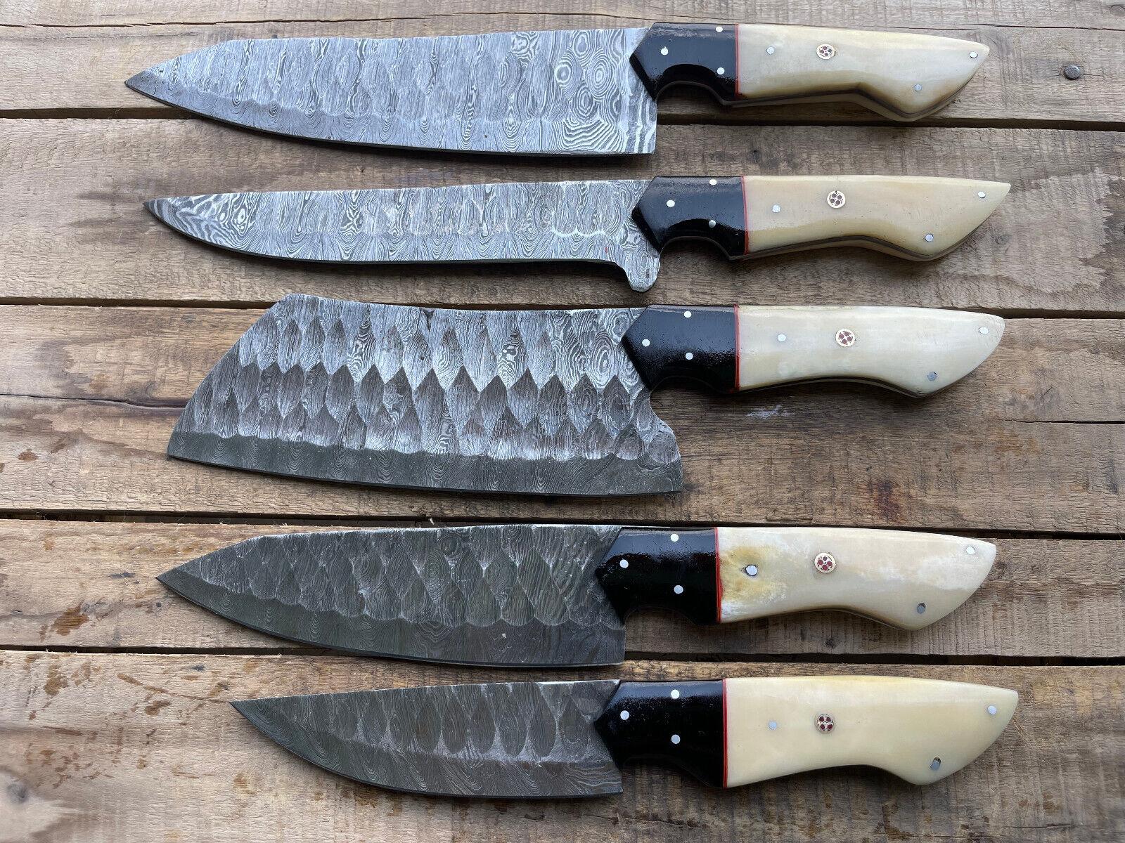 Close up detail of a Damascus steel kitchen knife blade with intricate metal patterns, showing professional grade grinding and high quality heat treatment.