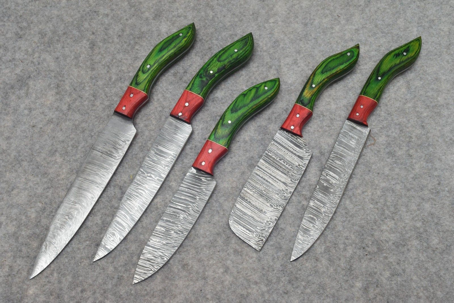 Detail view of authentic handmade Damascus steel blade pattern on a professional kitchen chef knife.