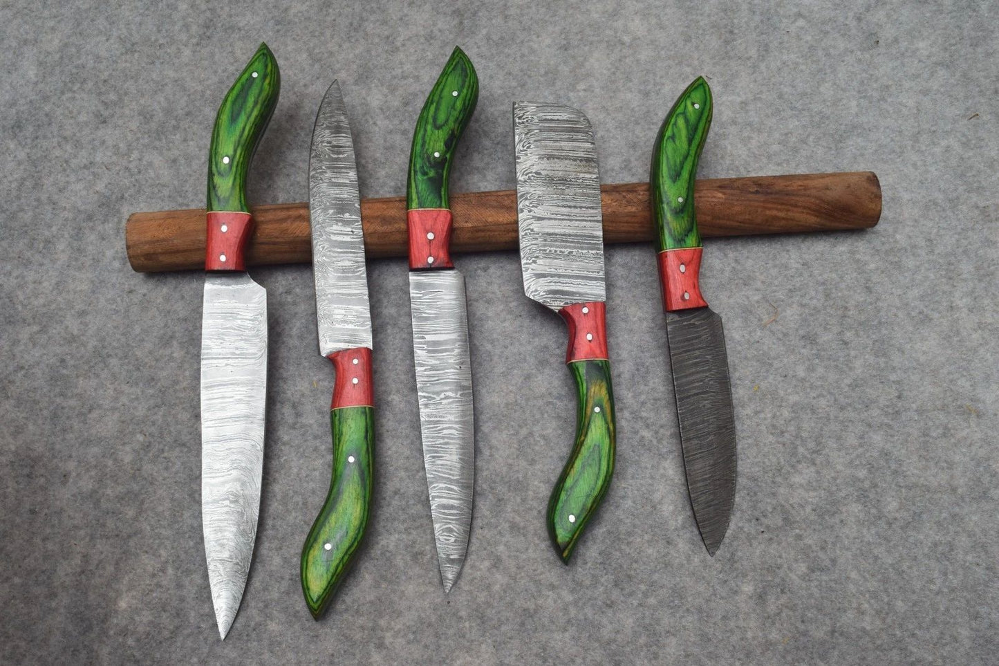 Close up of premium natural wood handle texture on a hand forged Damascus steel chef knife.
