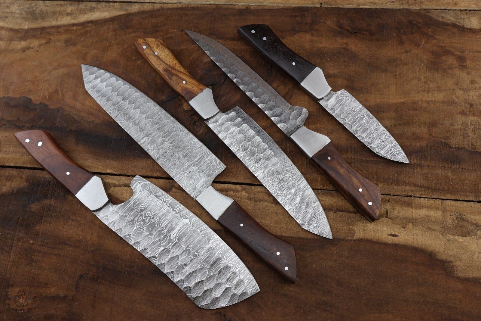 Detailed view of the 512 layer Damascus steel twist pattern and intricate spine file work on a professional grade culinary chef knife.