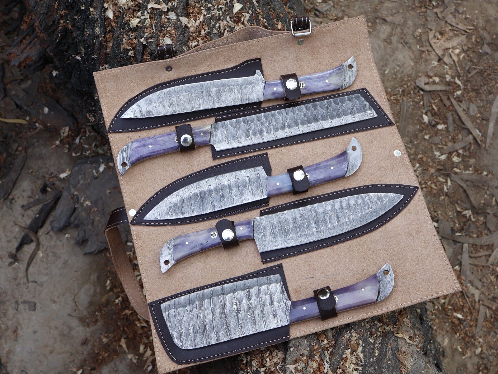 Complete 5 pieces Damascus steel chef knife set stored safely in individual leather sheaths.