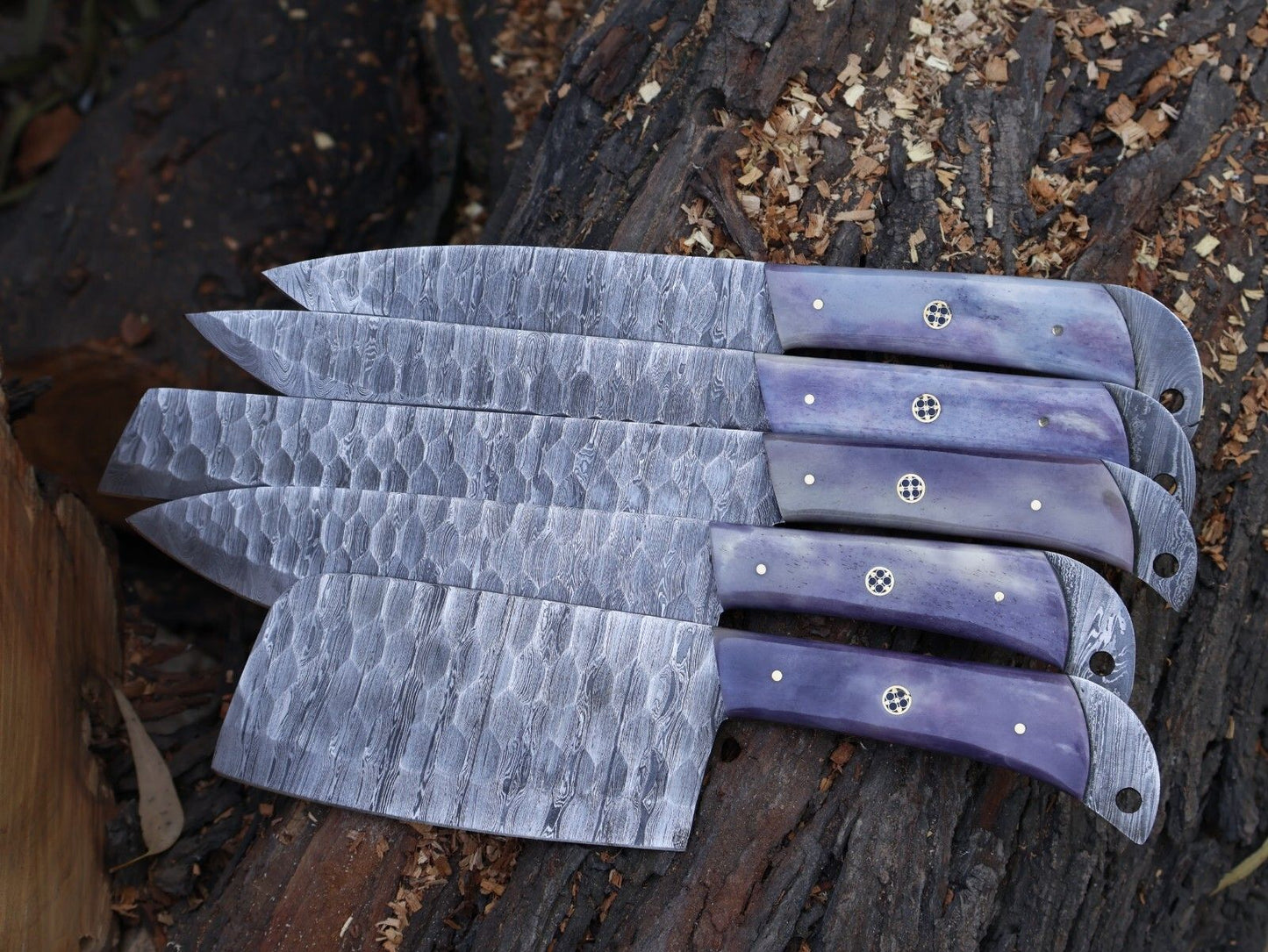 Complete 5 pieces Damascus steel chef knife set stored safely in individual leather sheaths.