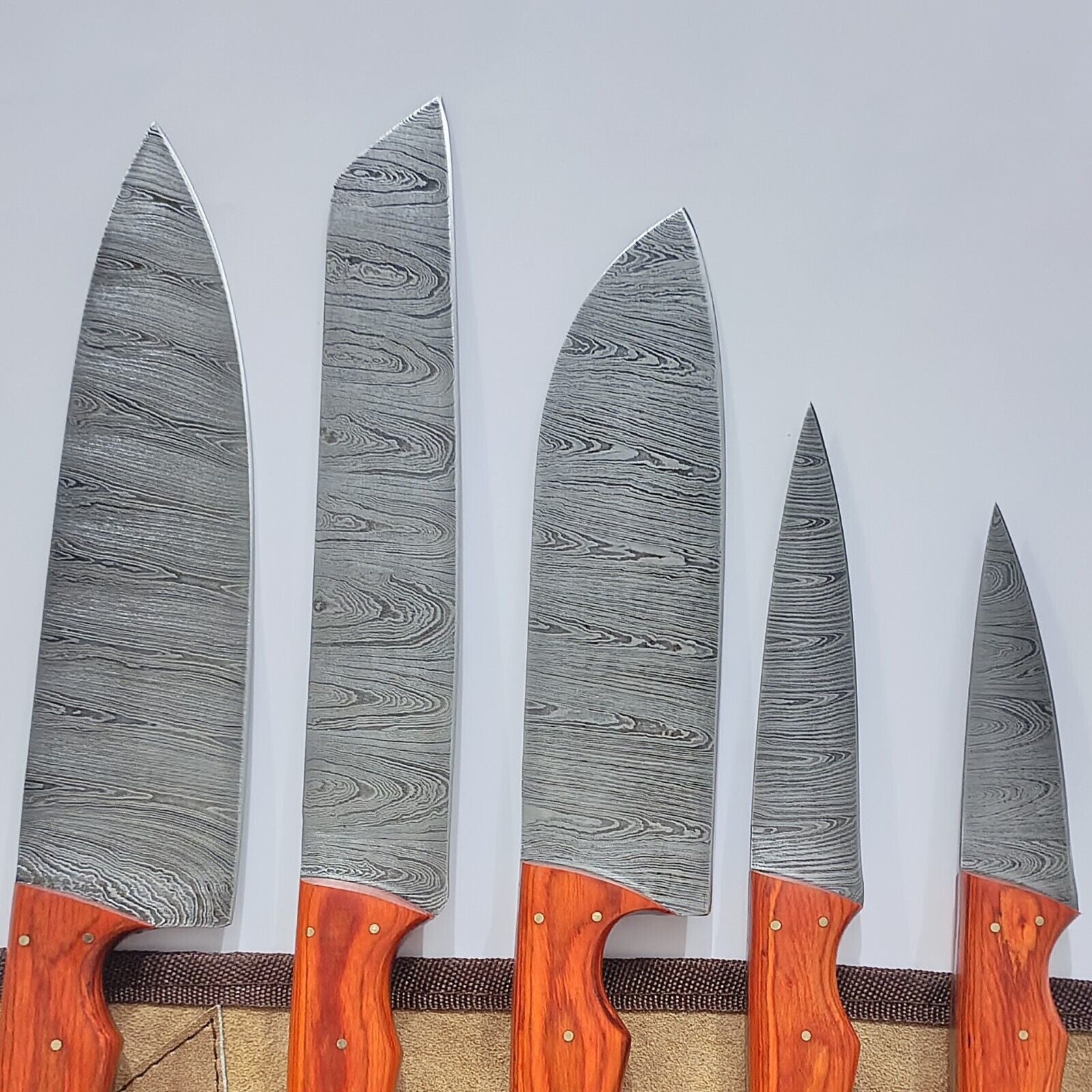 Close up view of 200 layer hand forged Damascus steel blade with a distinctive flowing water pattern.