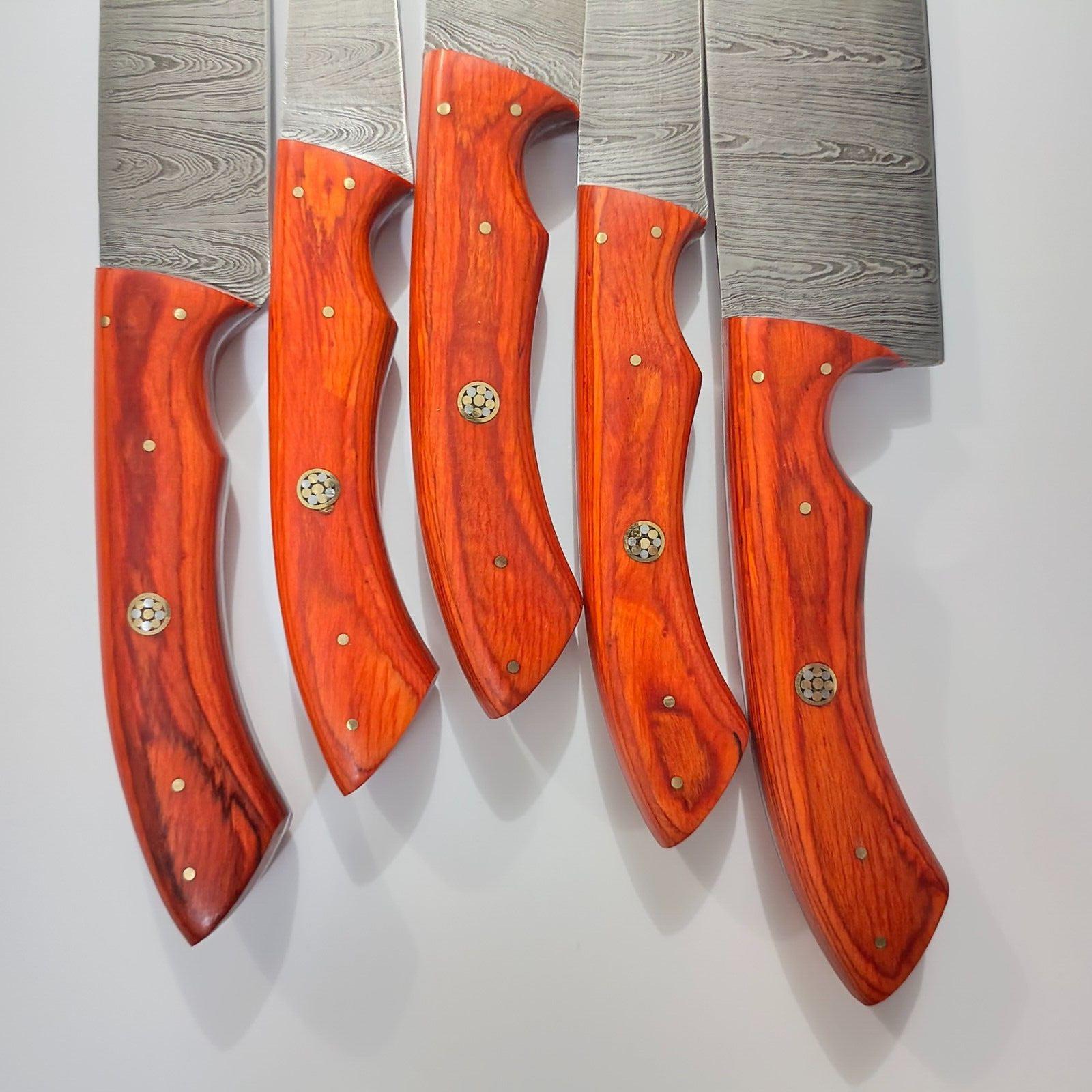 Detailed view of artisanal Pukka Wood handle secured with brass pins on a custom chef knife.