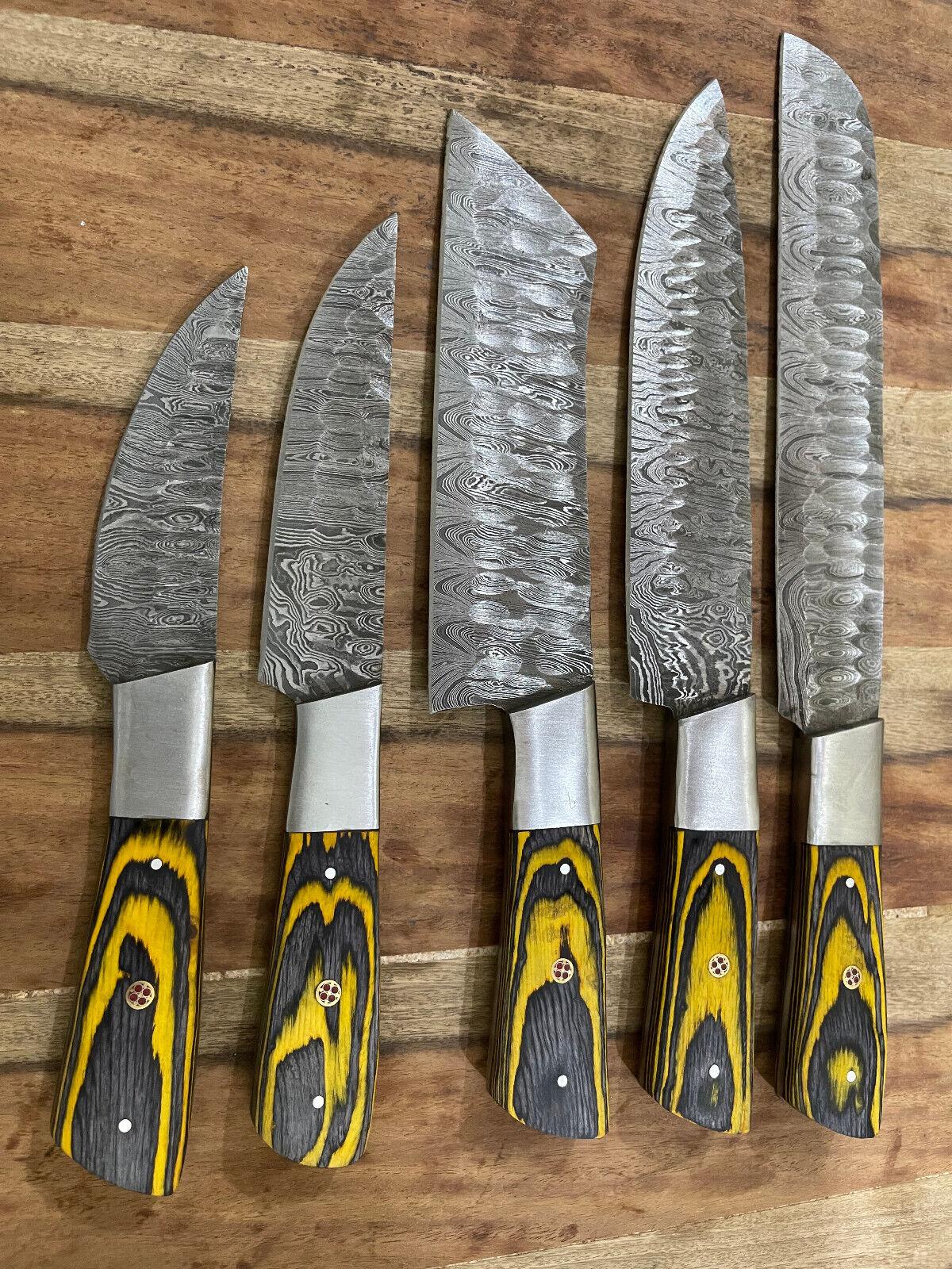 Detail view of a custom Damascus steel kitchen knife blade featuring professional hand grinds and 60 HRC hardness.