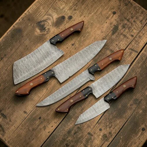 5 piece Damascus steel kitchen knife set with wooden handles displayed on a rustic wooden board
