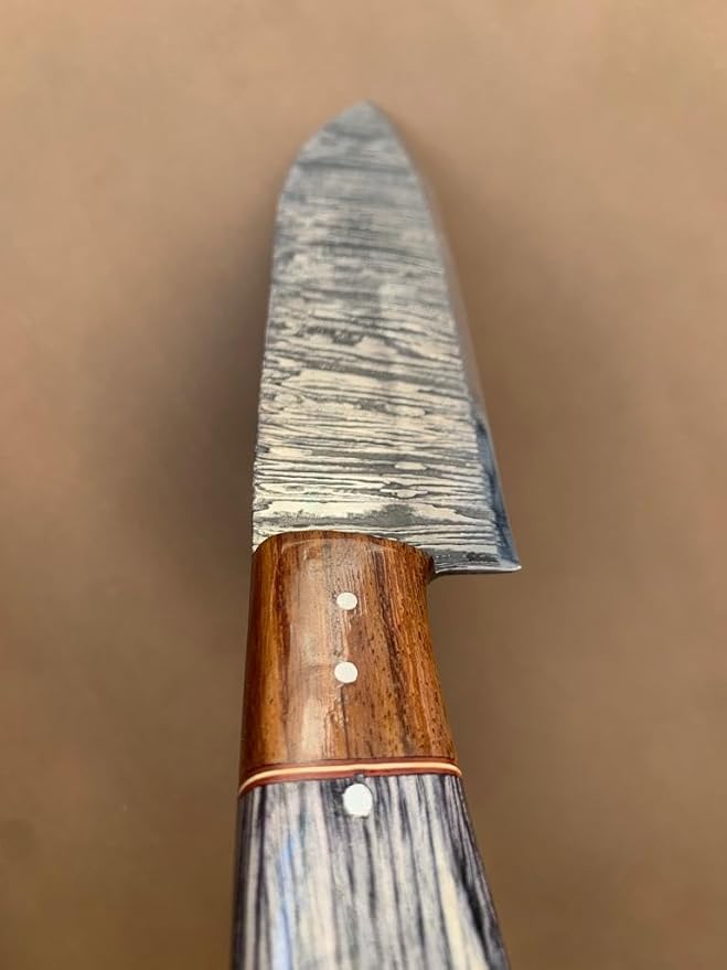 Close up of handle bolster with wood ferrule and pins