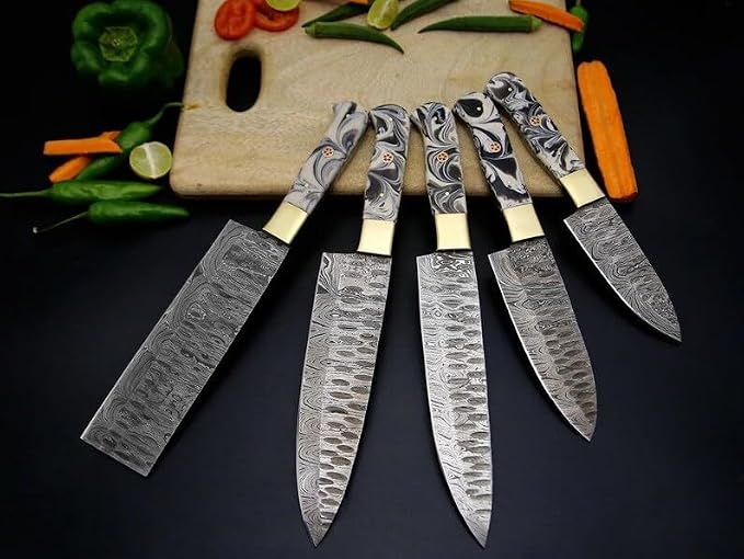 Close up of hammered and wavy Damascus steel blades with marbled acrylic handles