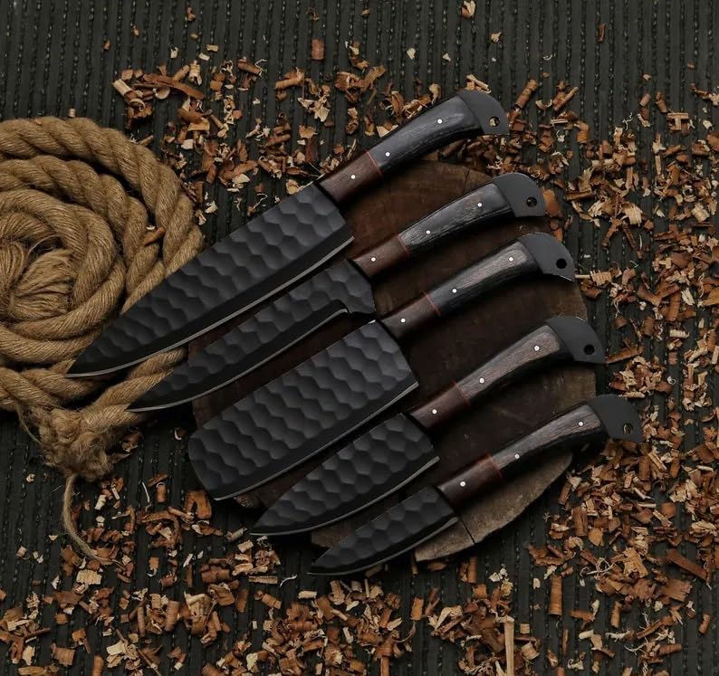 Black kitchen knife set of five with two tone wood handles fanned on a dark mat