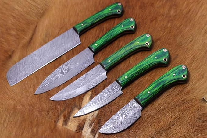 Close up of Damascus steel blades and green marbled handles with red and white star mosaic pins