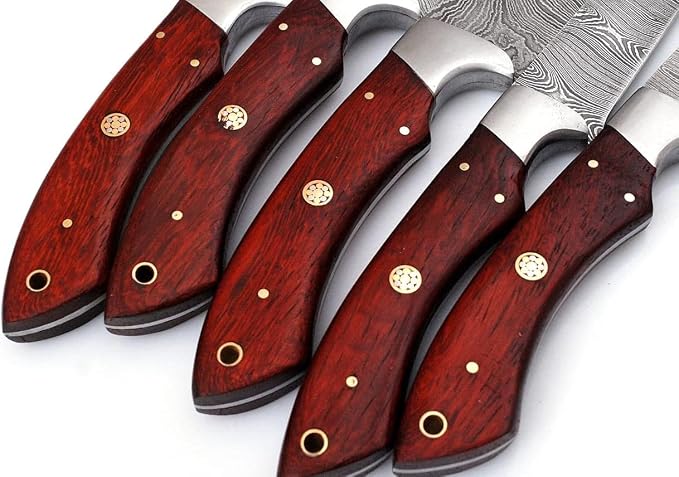 Close up of red wood knife handles with brass pins
