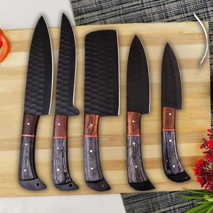 5 Pieces Damascus Steel Chef Knife Set with black textured blades and pakka wood handles beside fresh tomato