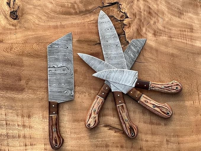 5 pieces Damascus knives and cleaver fanned on wood board