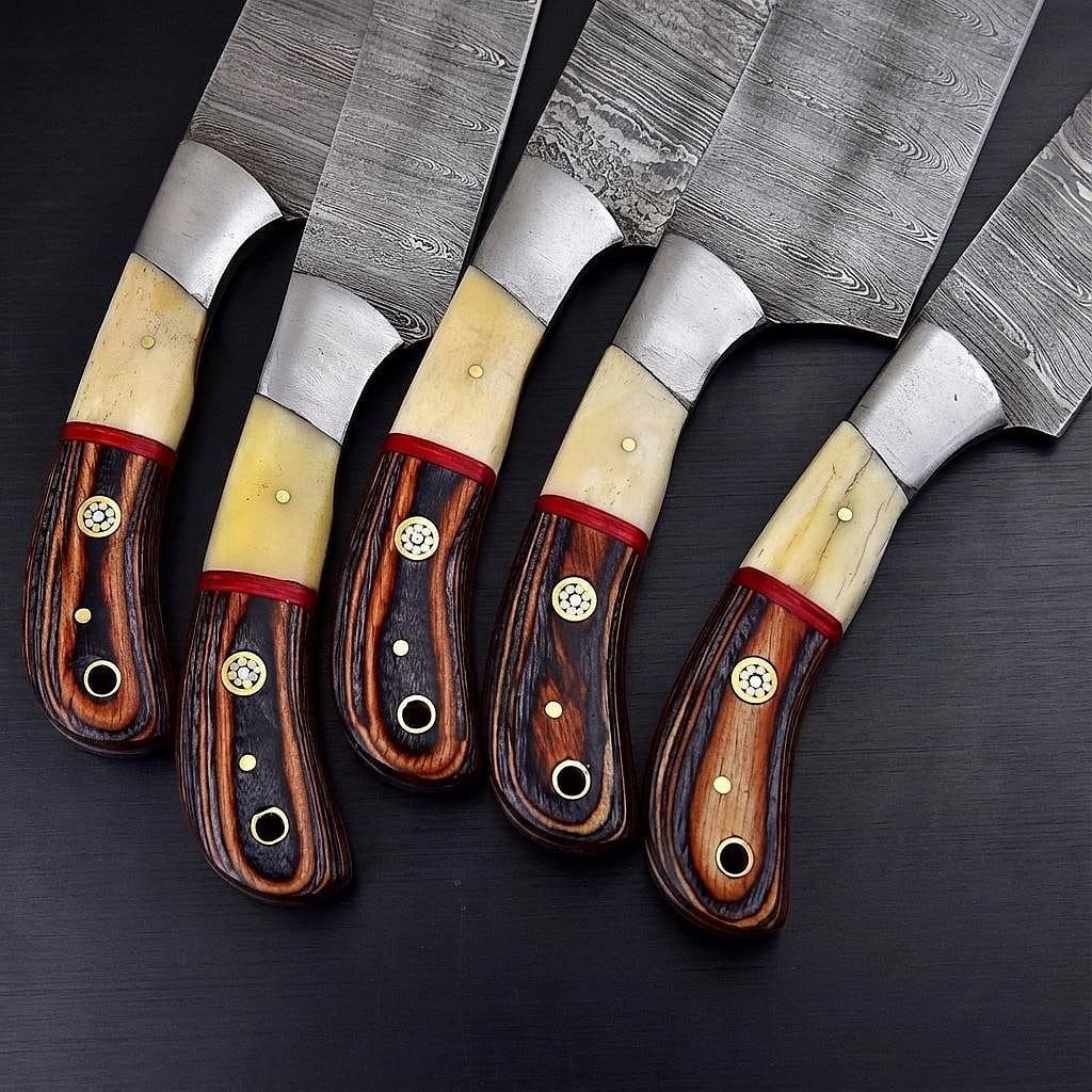 Custom Damascus chef knife resting on rough cut wood, highlighting the rugged outdoor aesthetic.
