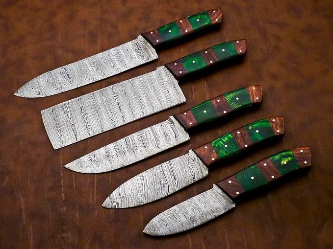 Damascus steel blades and striped green red handles fanned out close up