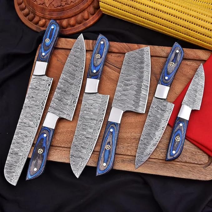 Pakka wood handle Damascus knives fanned diagonally on wood board