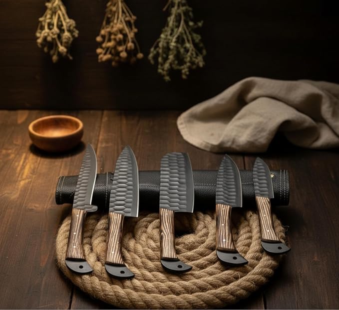 Five black kitchen knives with ashwood handles in a dark farmhouse kitchen