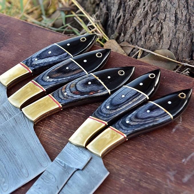 Close up of black and tan knife handles with brass pins