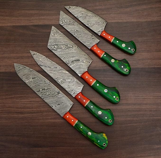 Damascus steel knives with orange and green pakka wood handles fanned close up