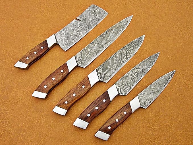 Damascus steel knife set fanned out with pakkawood handles, a cleaver, two chef knives, utility and paring knife
