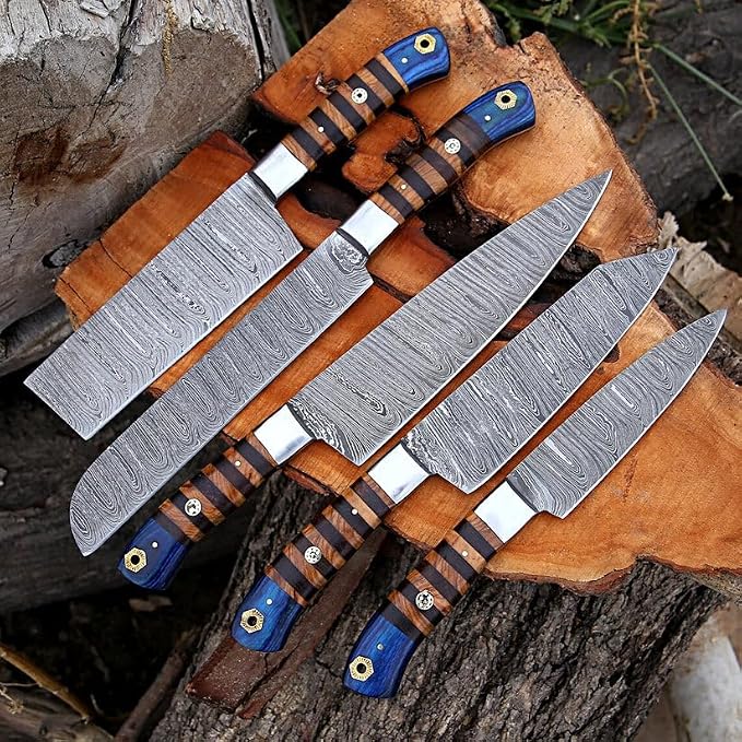 5 Damascus knives with pakka wood handles fanned on log background