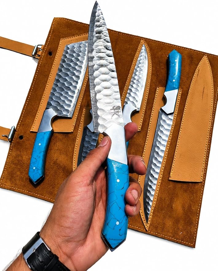 Close up of Damascus steel chef knife with hammered blade and blue acrylic handle
