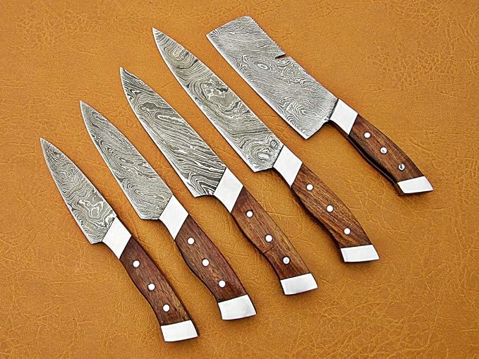 Damascus steel chef knife set tips up, from paring knife to cleaver, with a flowing pattern on each blade