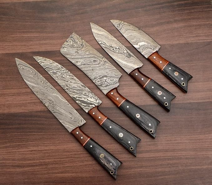 Damascus steel knives with orange and gray wood handles fanned close up