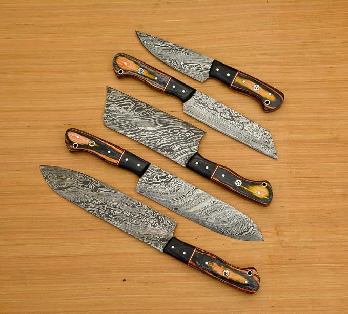 Close up fan of 5 pakka wood handle Damascus knives, blades crossed