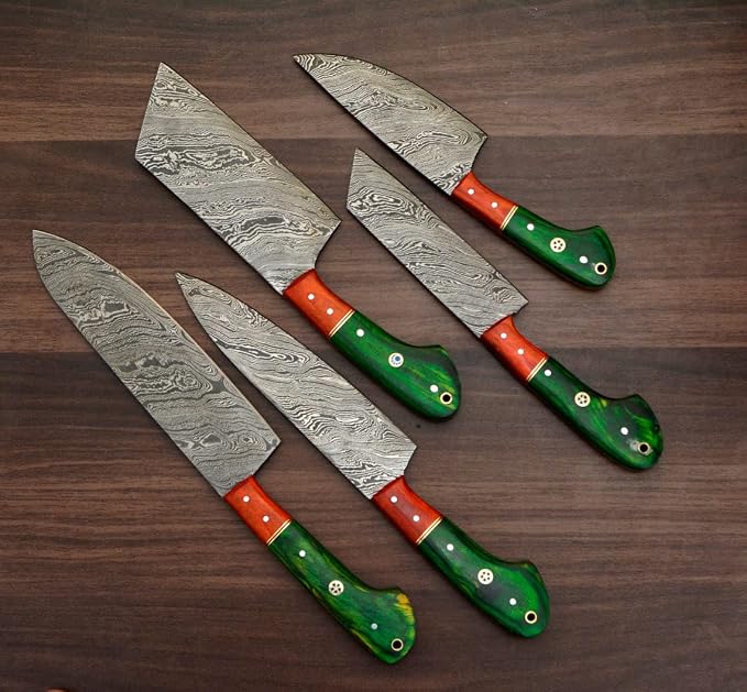  Damascus steel knives with orange and green pakka wood handles fanned close up