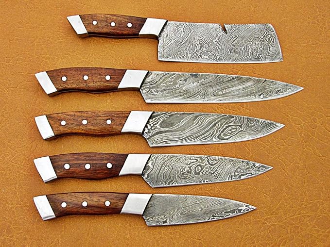 Damascus steel chef knife set side view showing the cleaver notch and five blade profiles by size