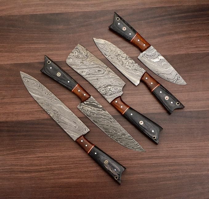 Damascus steel knives with orange and gray wood handles fanned close up