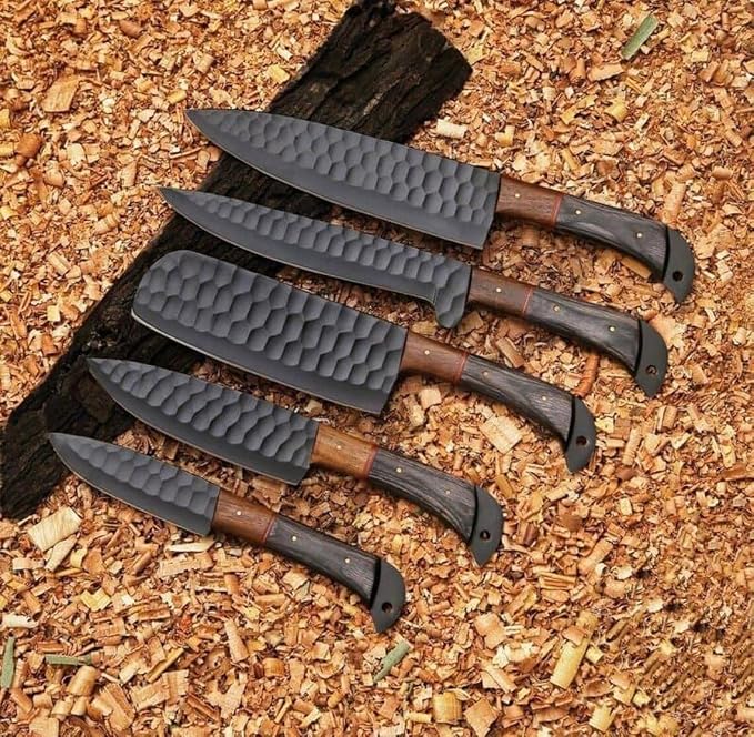 5 Pieces Damascus Steel Chef Knife Set with pakka wood handles laid across wood chips near a dark log