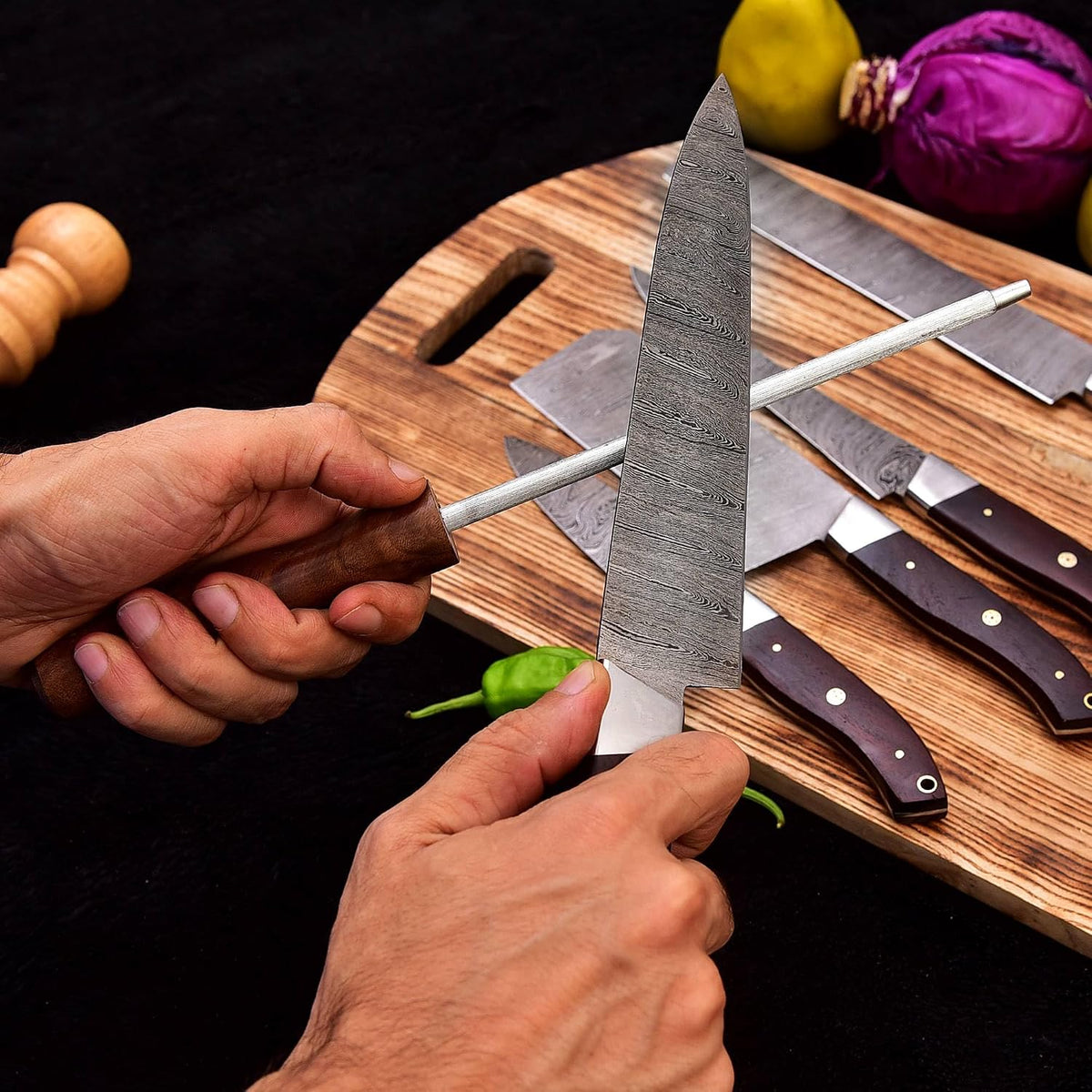 Sharpening a Damascus steel blade using the included rod from the 5 Pieces Chef Knife Set