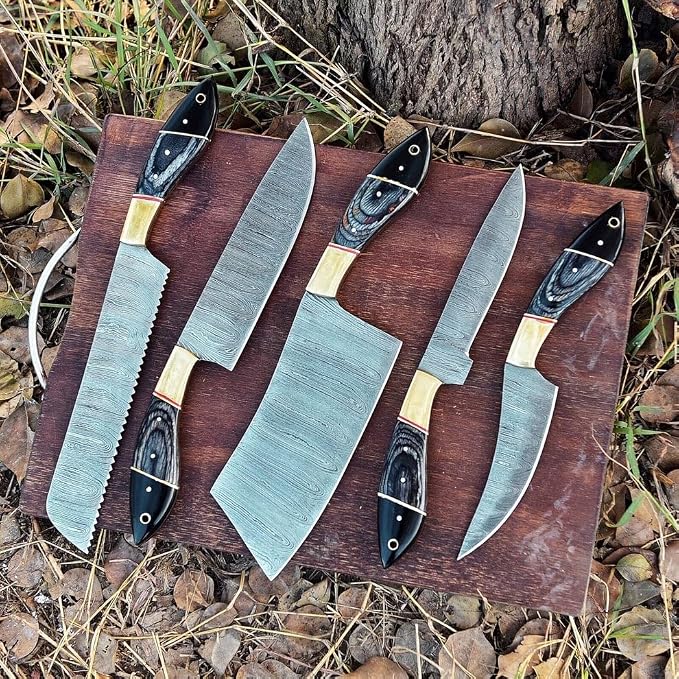5 piece knife set with black and tan handles arranged outdoors