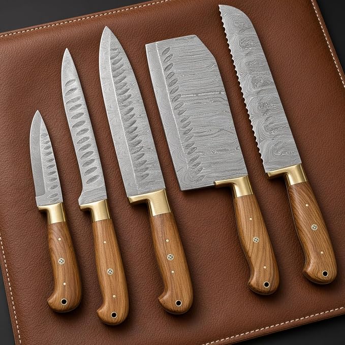 Damascus knife set of five with olive handles laid on a brown leather mat