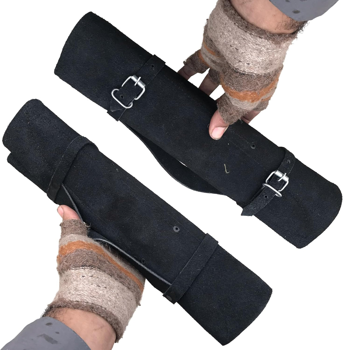 Black leather knife roll buckled shut and held in two hands, ready to carry