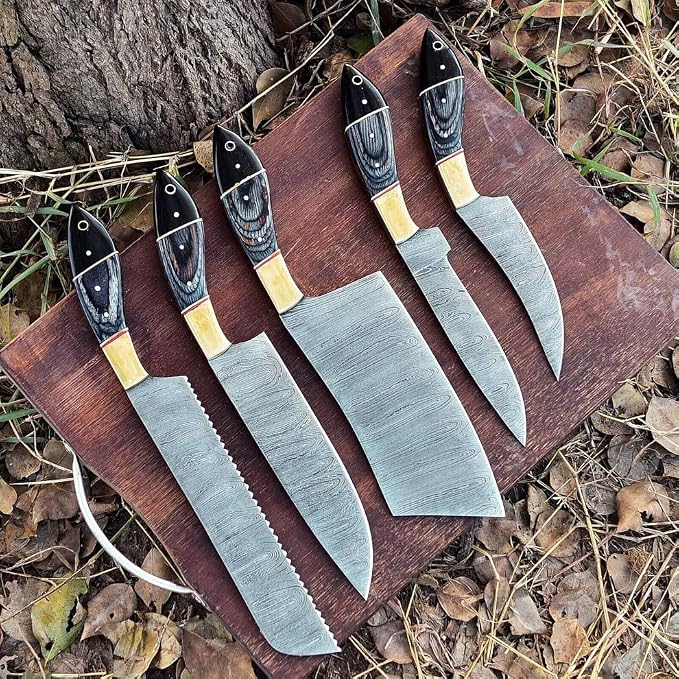 5 piece knife set with black and tan handles on wood board