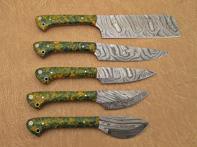 5 piece Damascus steel knife set with acrylic handles arranged closely showing hand forged blade pattern