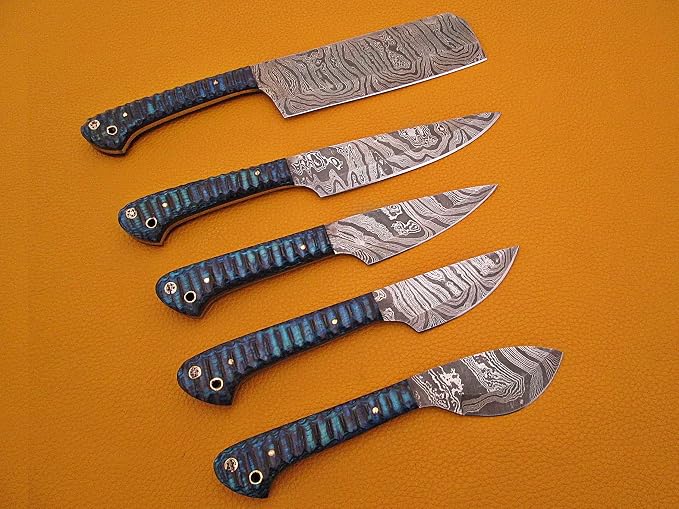 Close up of 5 piece Damascus steel knife set showing blue and grey acrylic handles and hand forged blade pattern