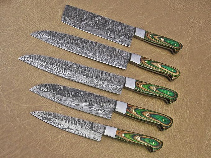 Damascus steel knife set with green pakka wood handles fanned on a leather background