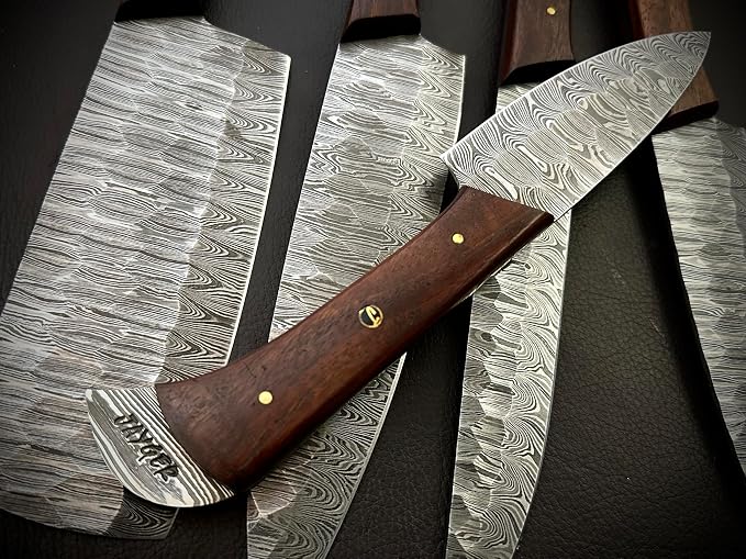 Close up of a Damascus steel blade and wood handle with brass pins