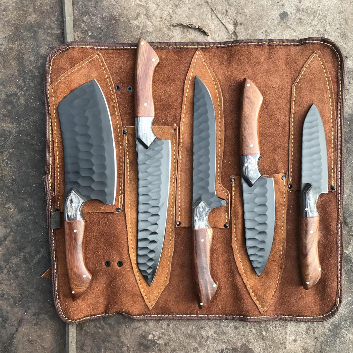 Black kitchen knife set of five in a tan leather roll with fitted sheaths