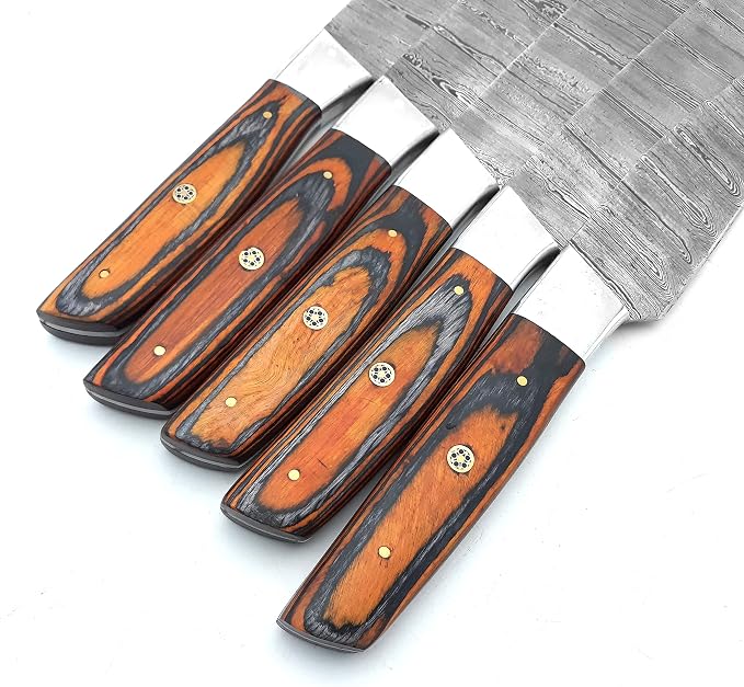 Close up of orange and black knife handles with brass pins