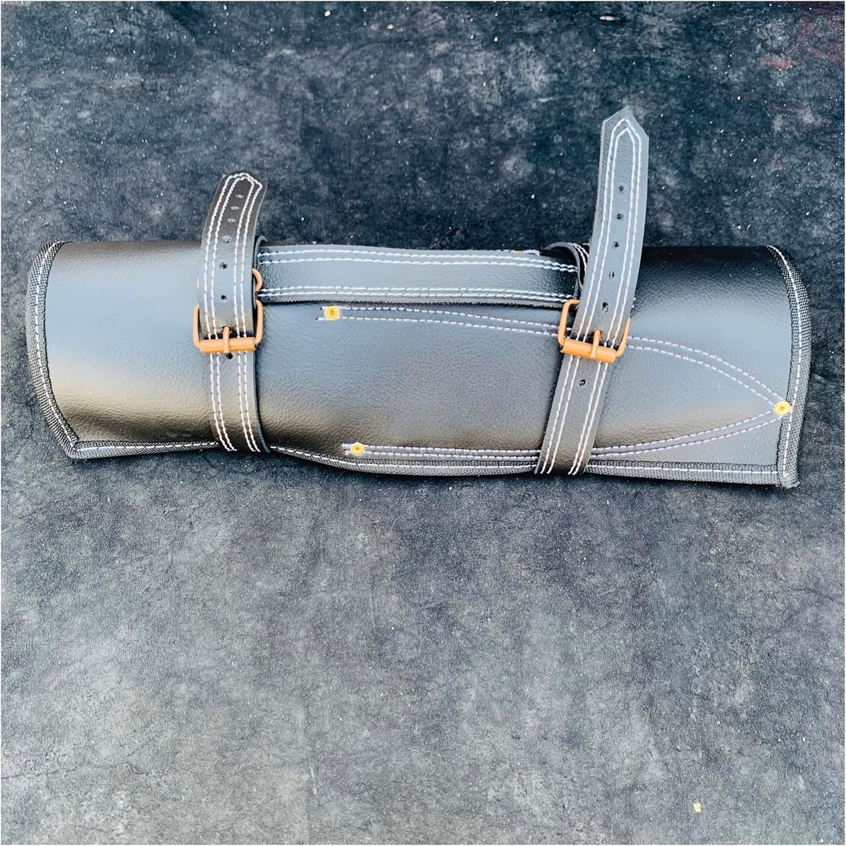 Black leather roll case for the 5 Pieces Black Finish Steel Chef Knife Set, shown closed
